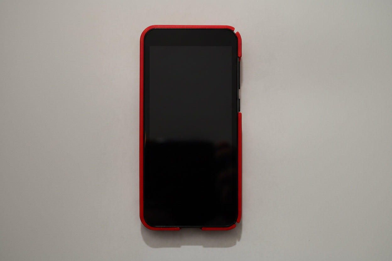 Black smartphone with red case on a light gray background