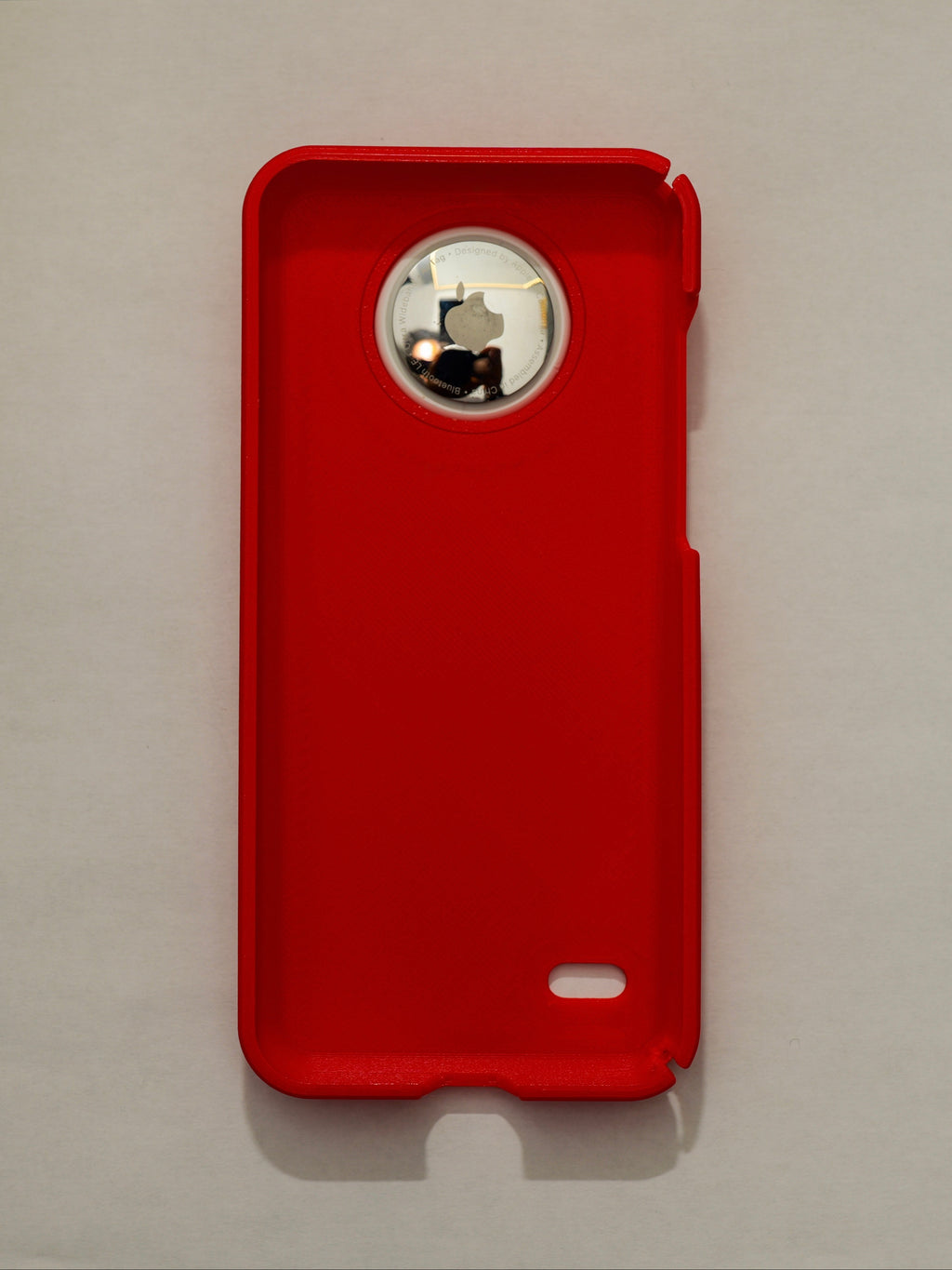Red phone case with a brand logo on a light gray background
