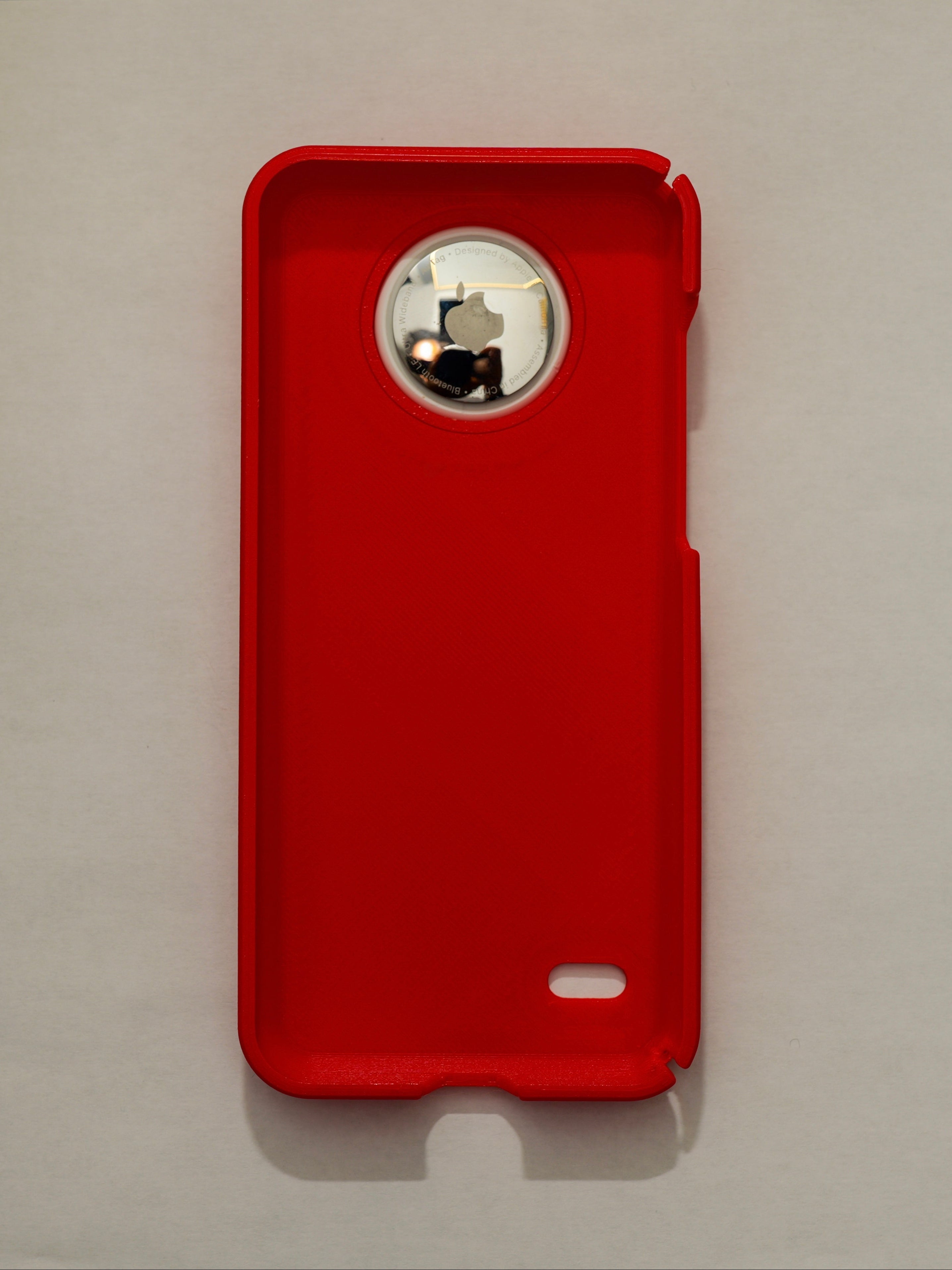 Red phone case with a brand logo on a light gray background