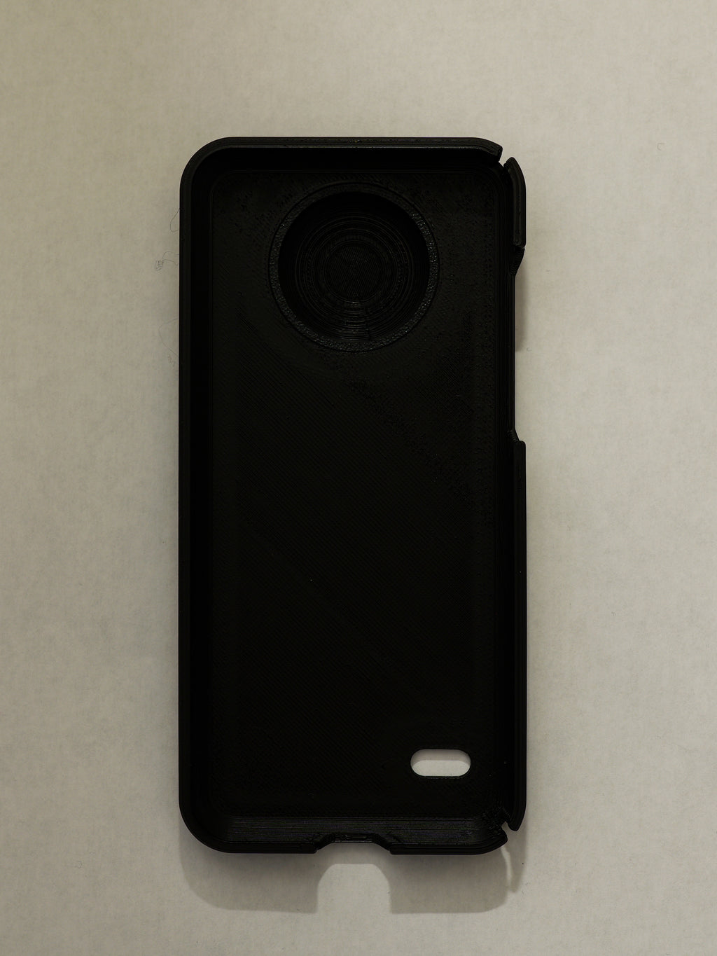 Black phone case on a beige background