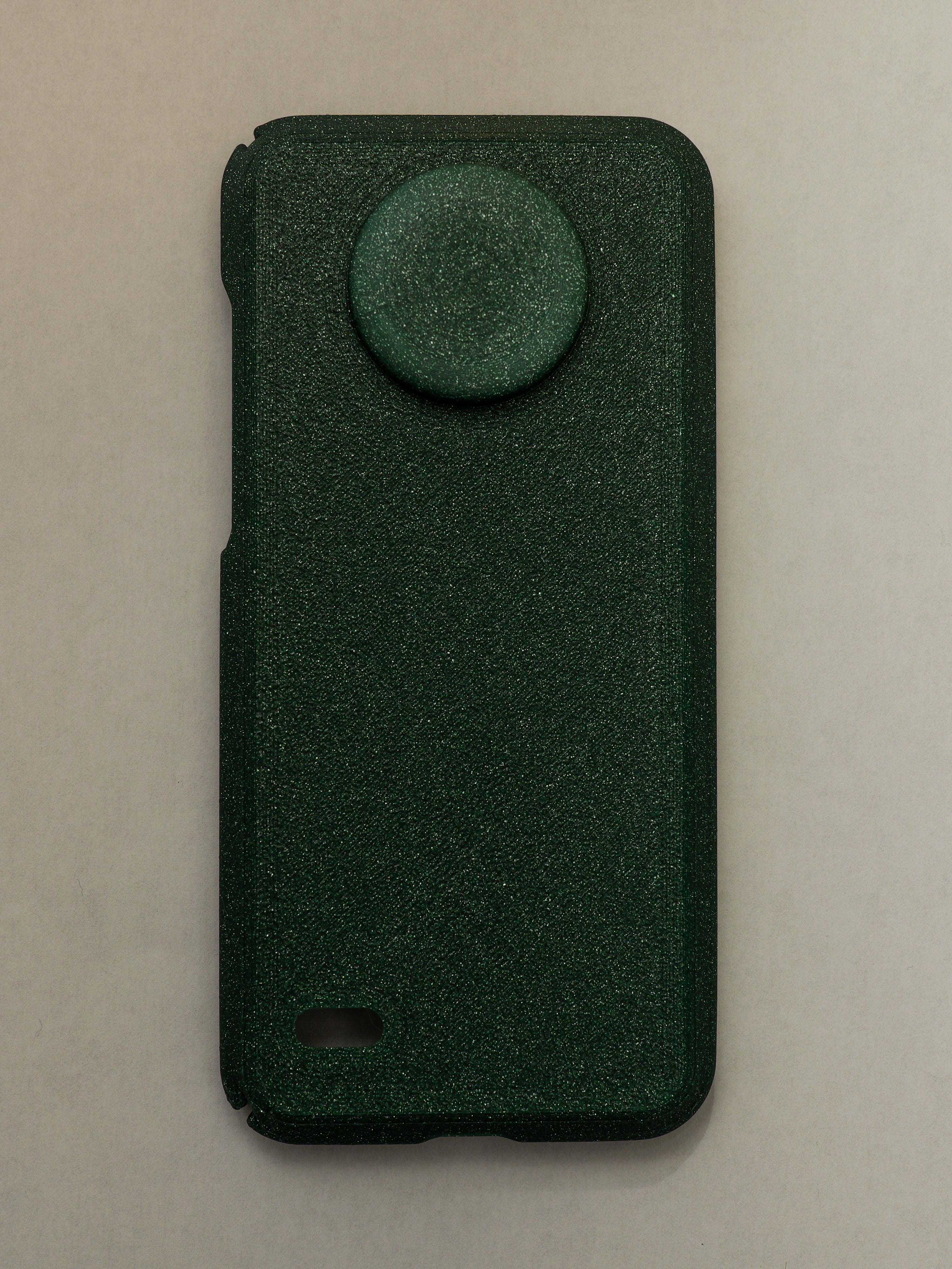 Green phone case with a circular design on a beige background