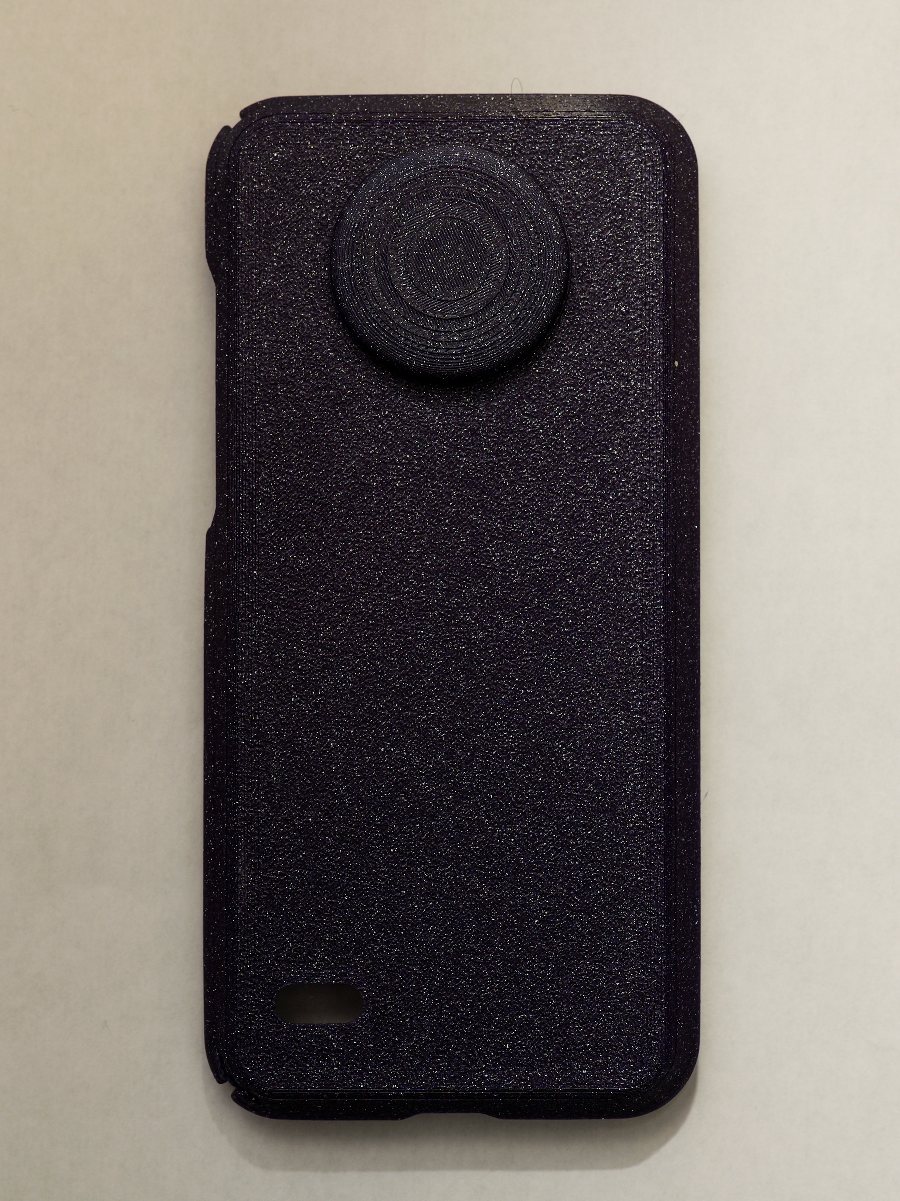purple textured phone case with a circular design on a beige background