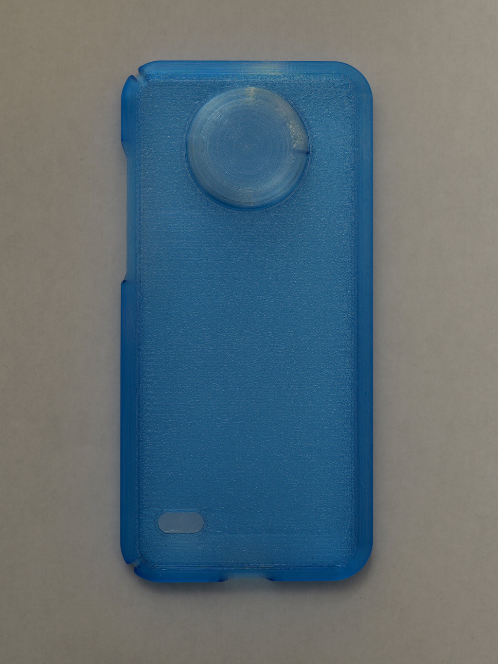 Blue phone case with a circular design on a beige background