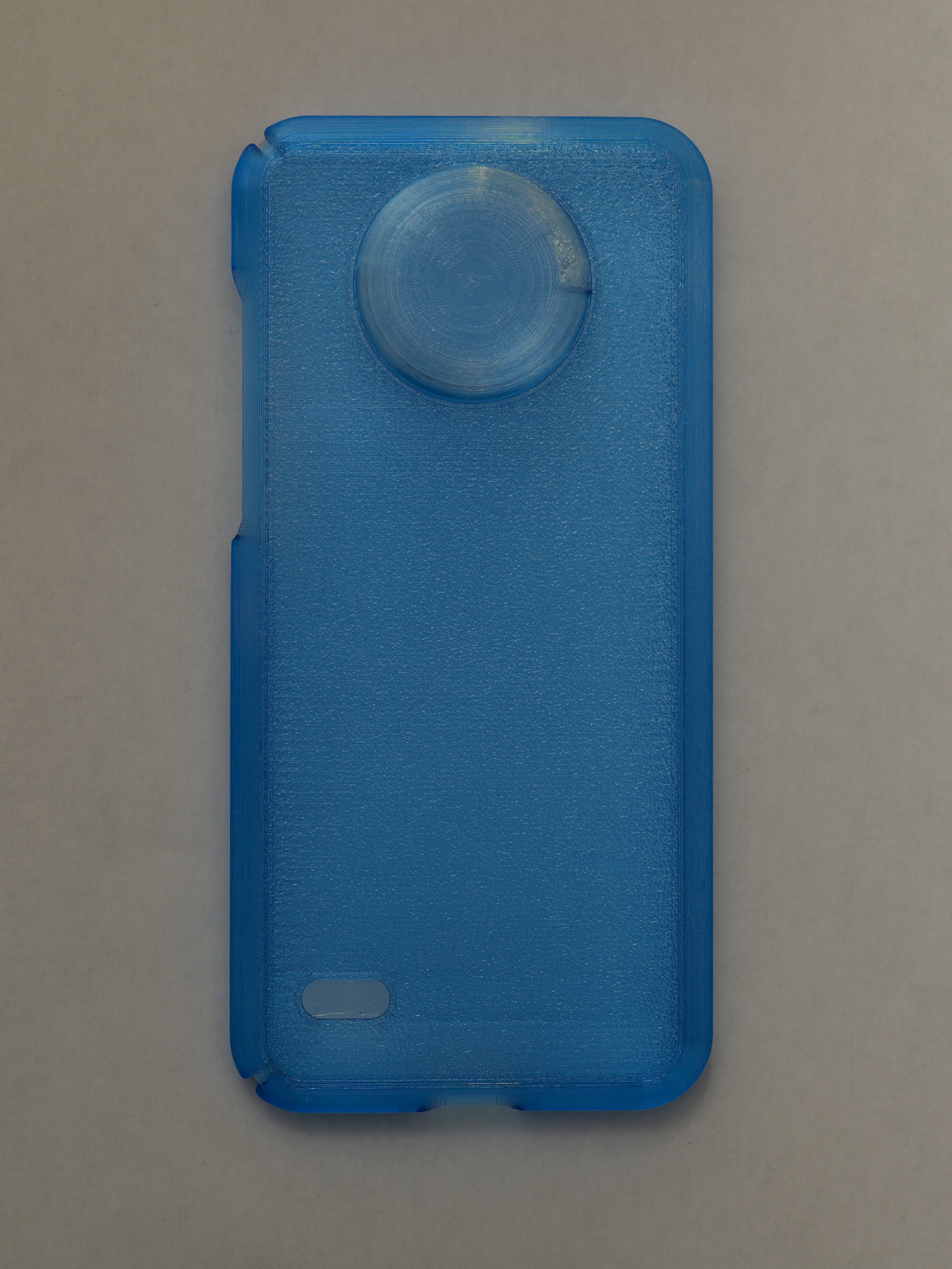 Blue phone case with a circular design on a beige background