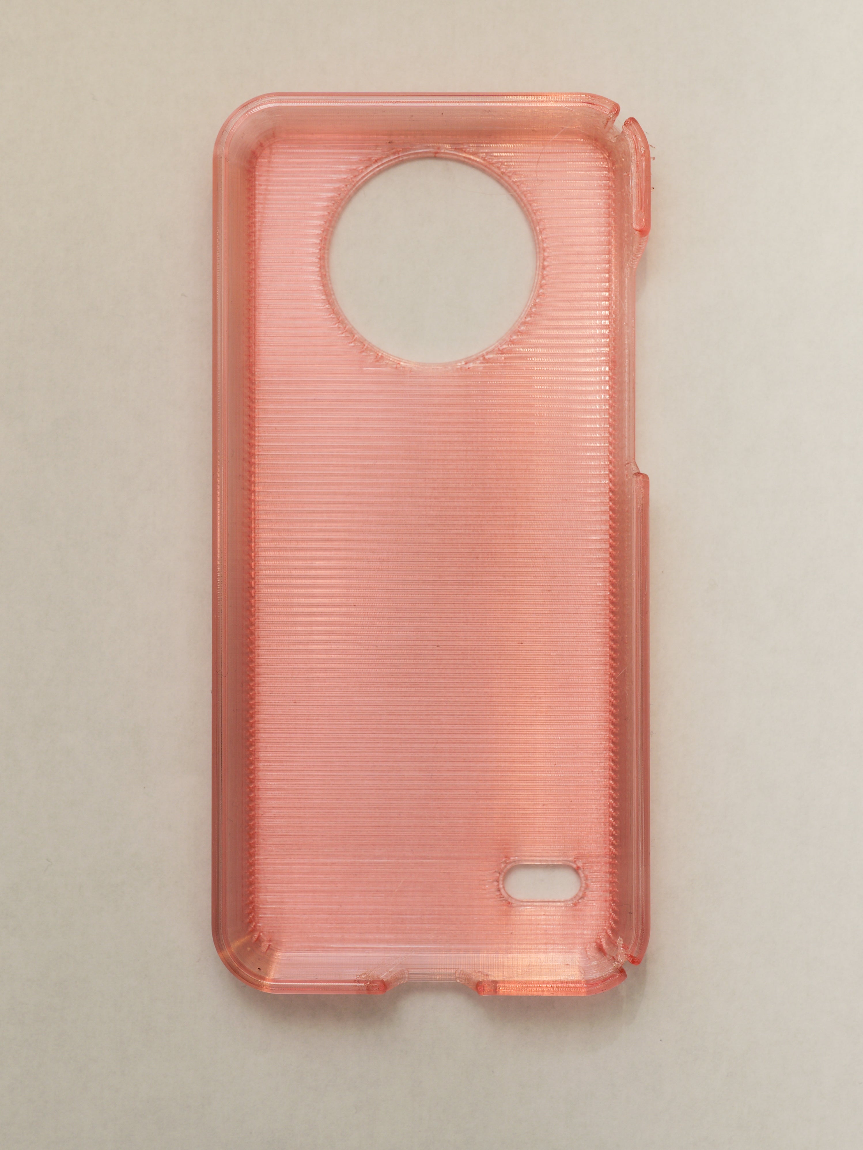 Clear pink phone case on a beige background